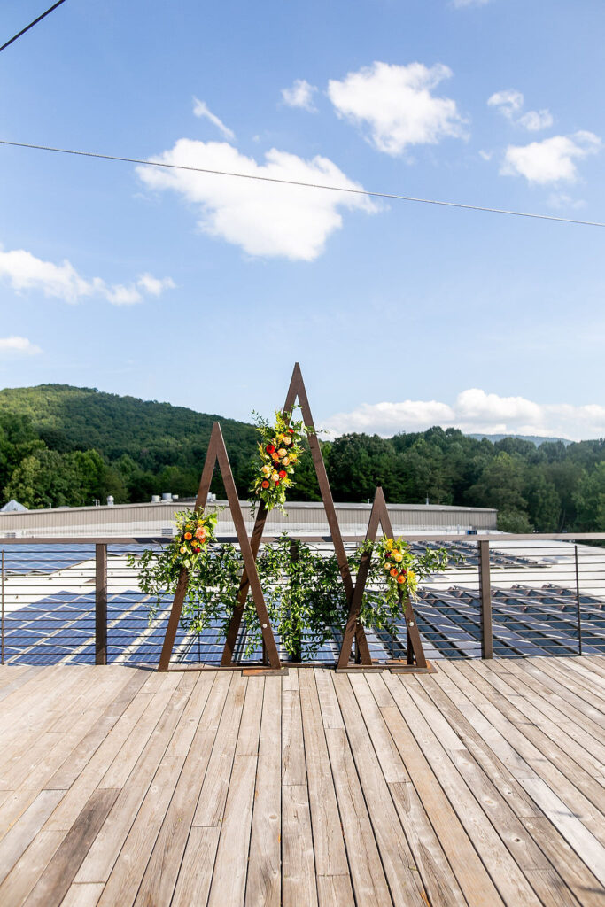 Wooden triangle decorated with flowers on a rooftop 