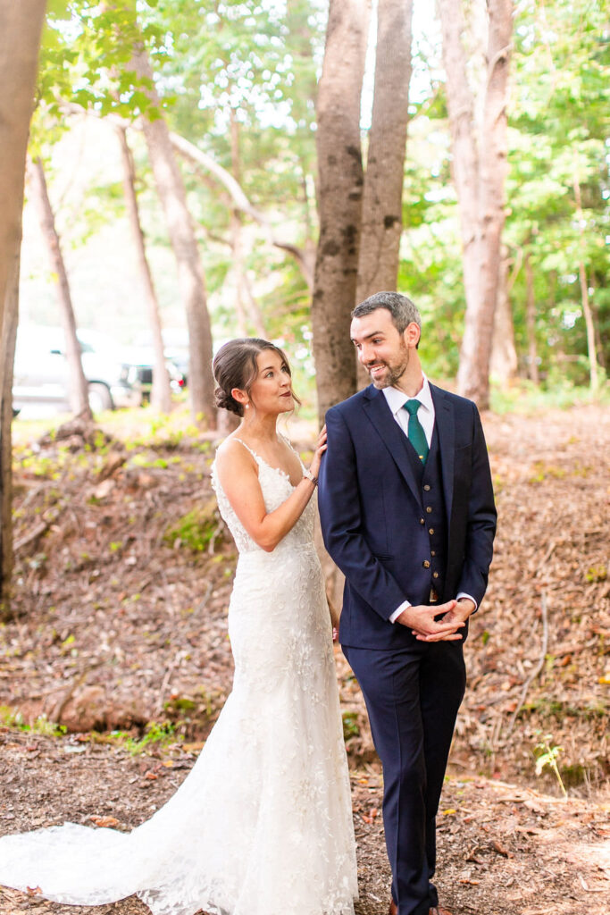 A bride tapping a groom's shoulder during their first look. 