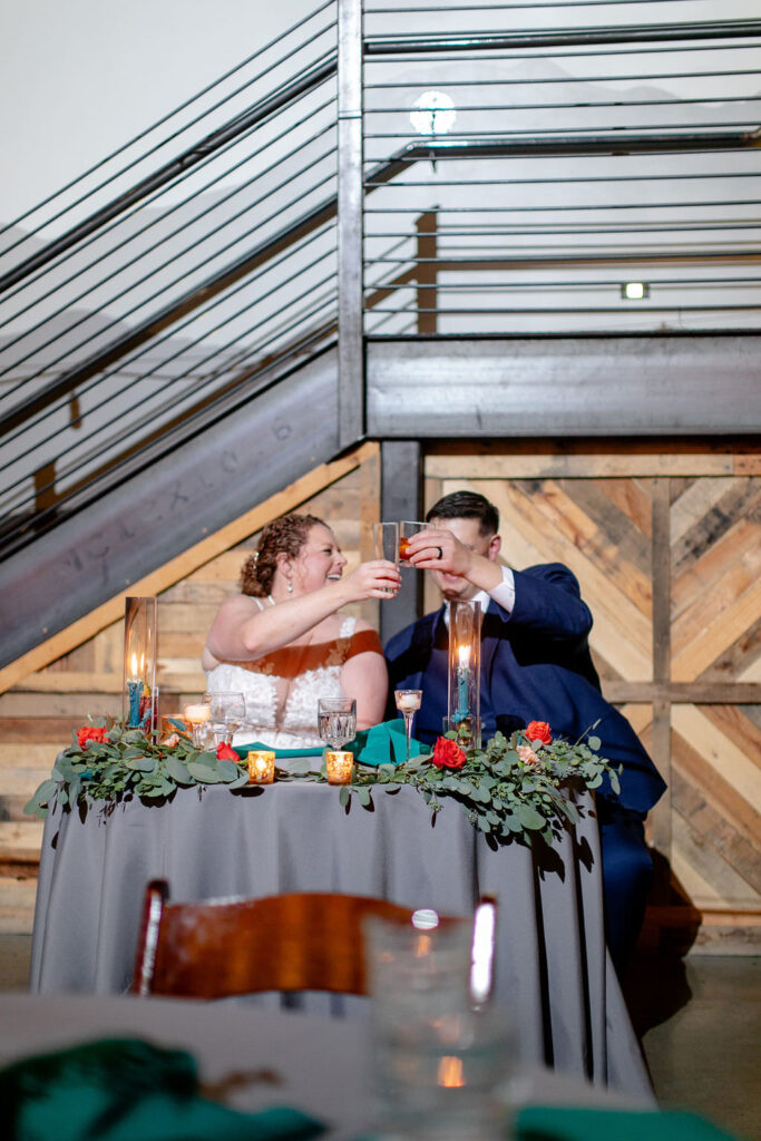 A wedding couple toasting their classes during their reception. 