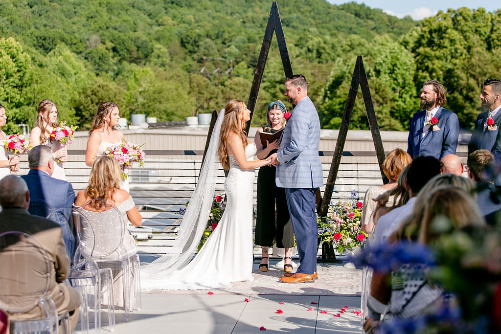 A couple standing up together saying their vows 
