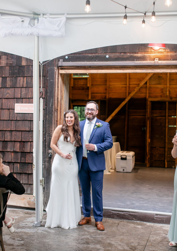 bride and groom smiling with champange glasses