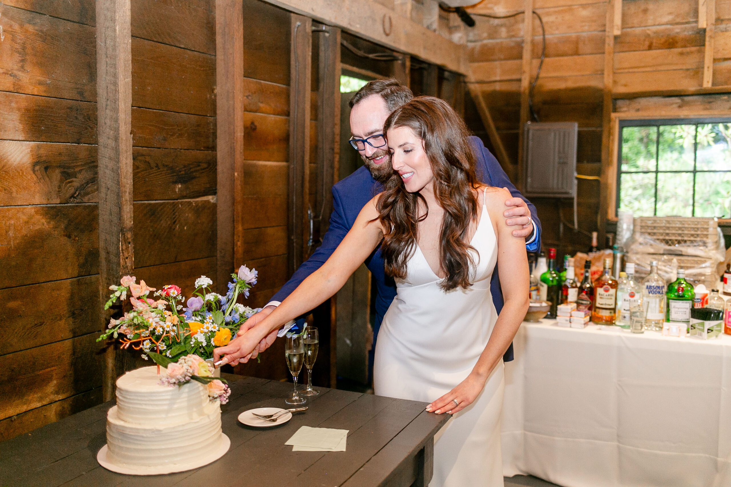 bride and groom cutting wedding cake