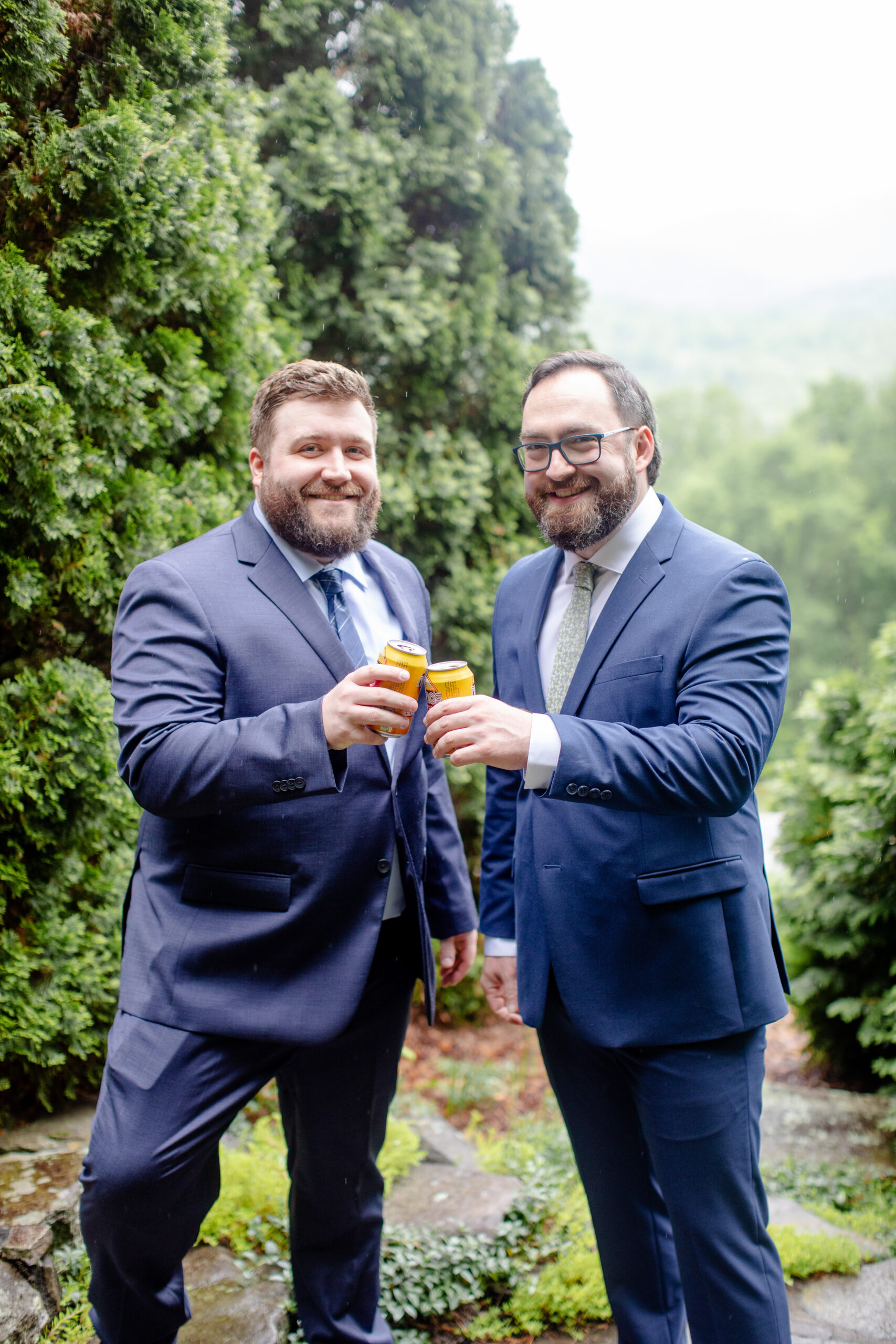 groosmen and groom holding drinks