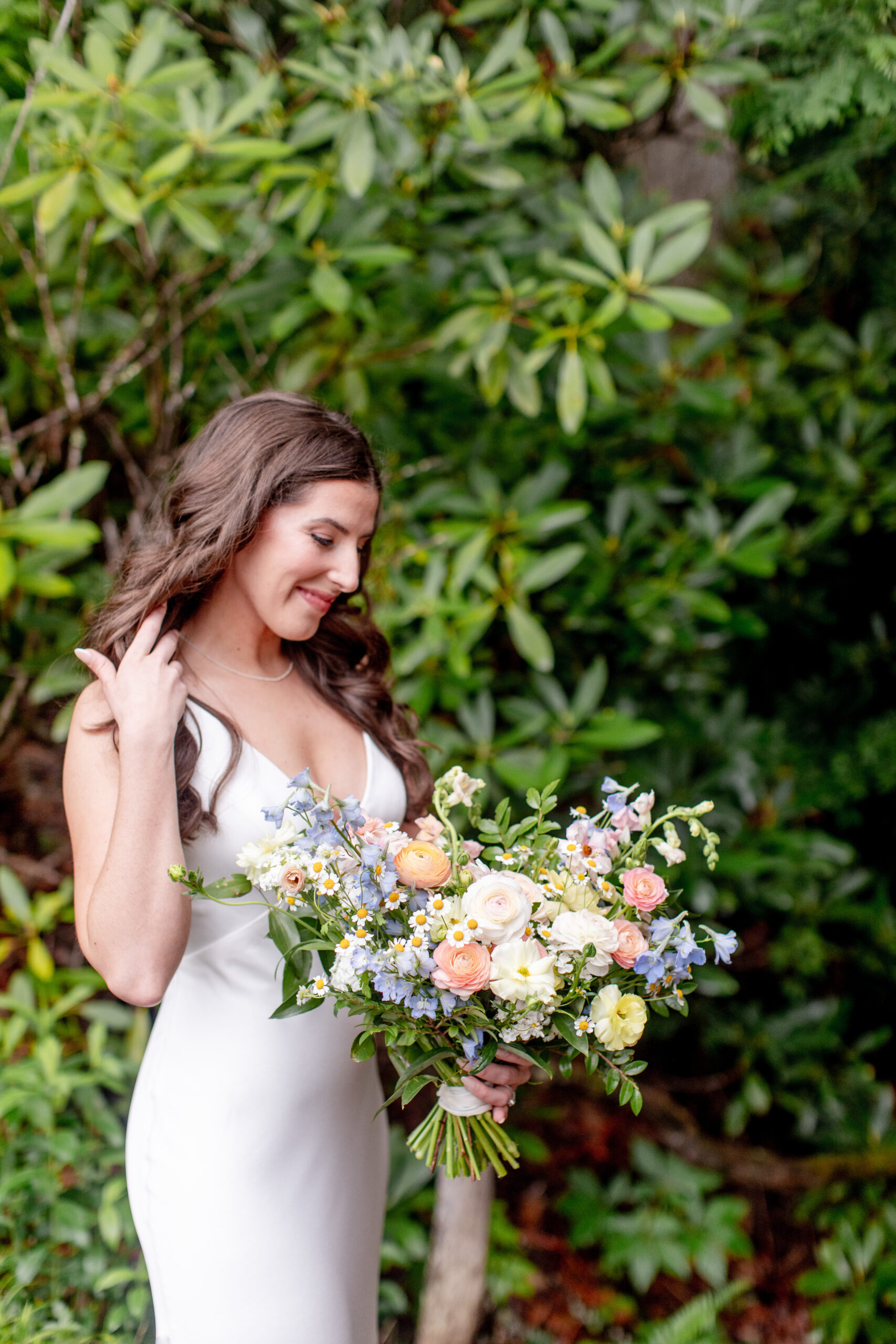 Bride holding boquet of flowers looking down