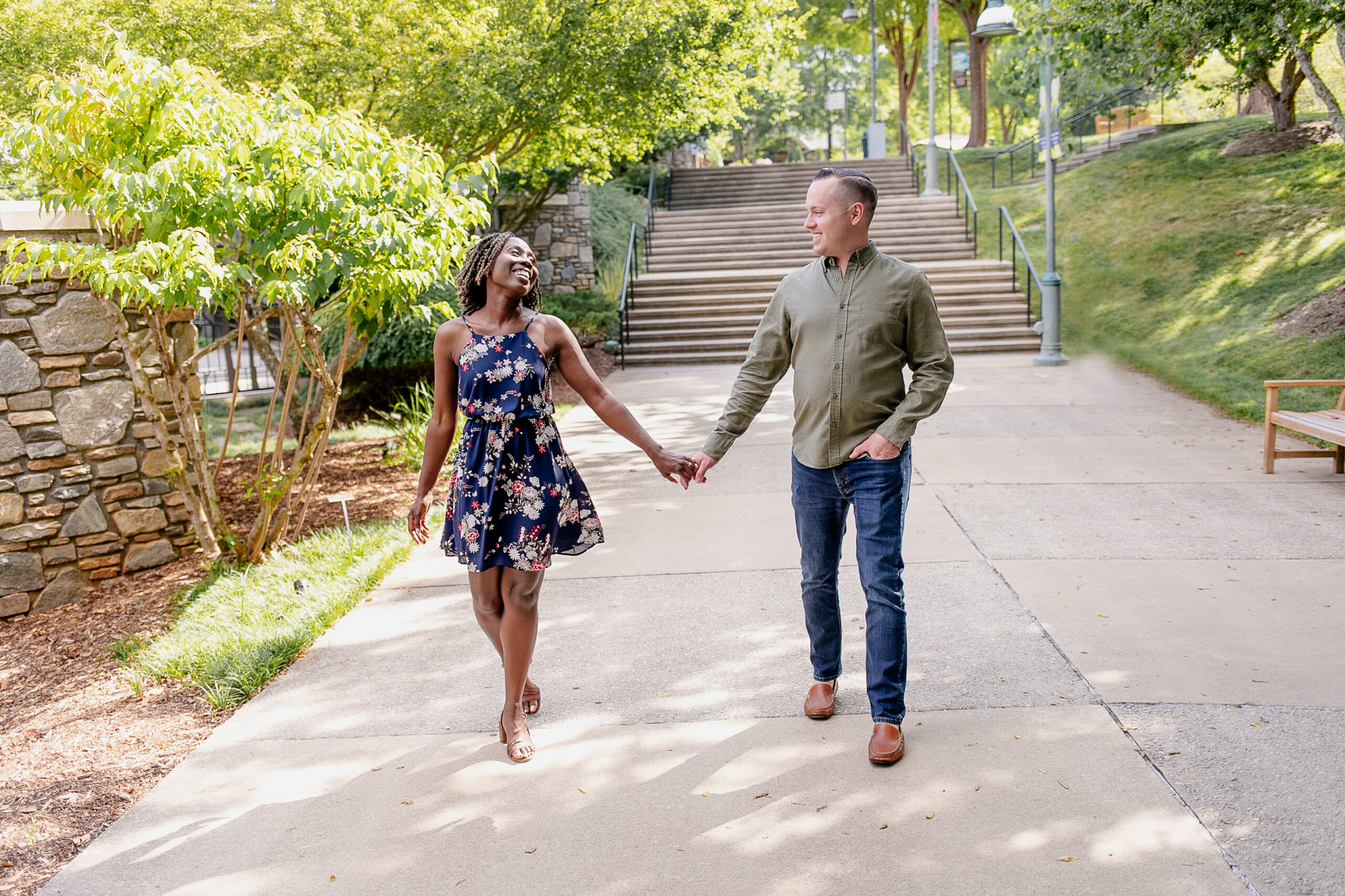 a woman and a man walking towards the camera holding hands 