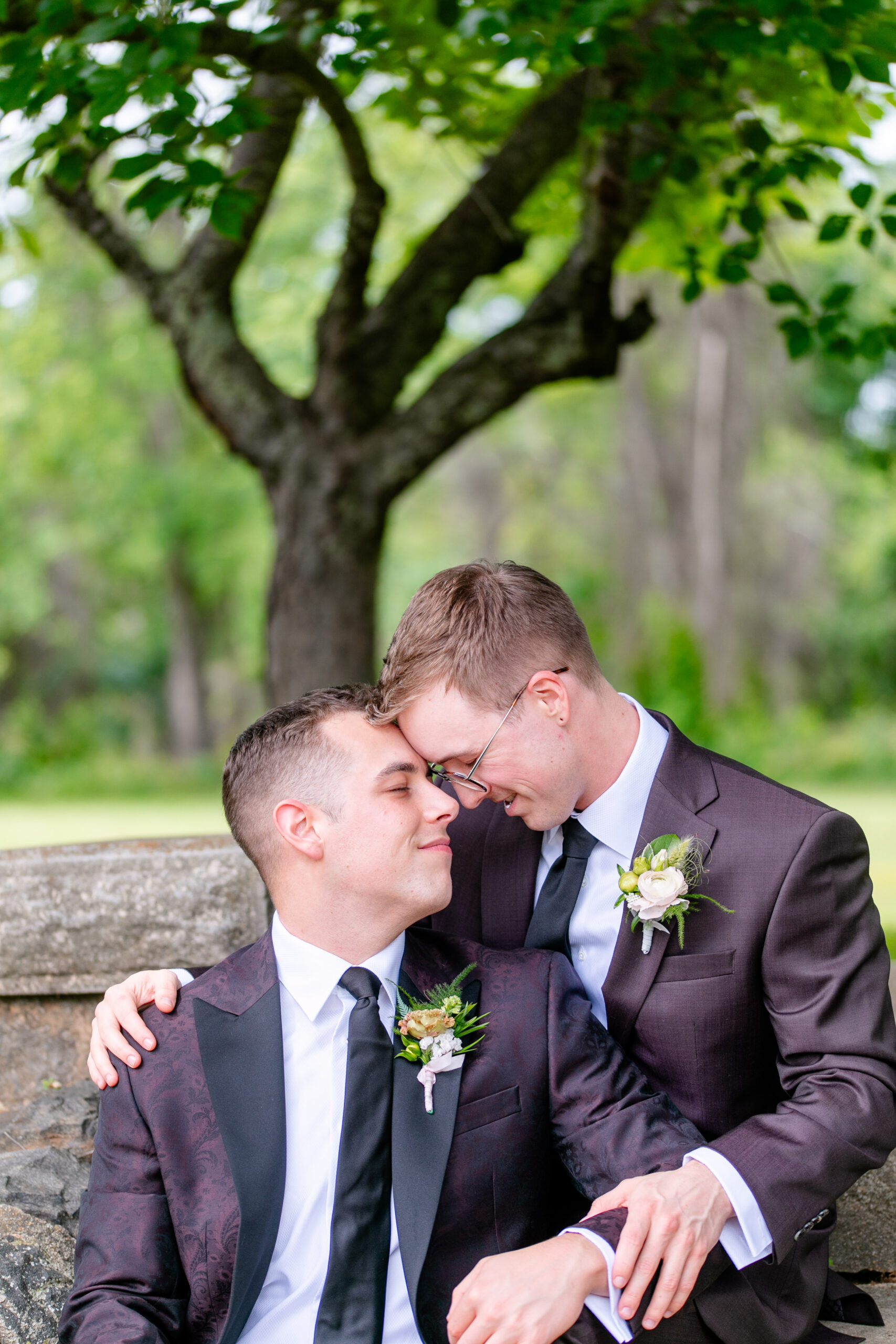 two men holding each other with their heads touching 