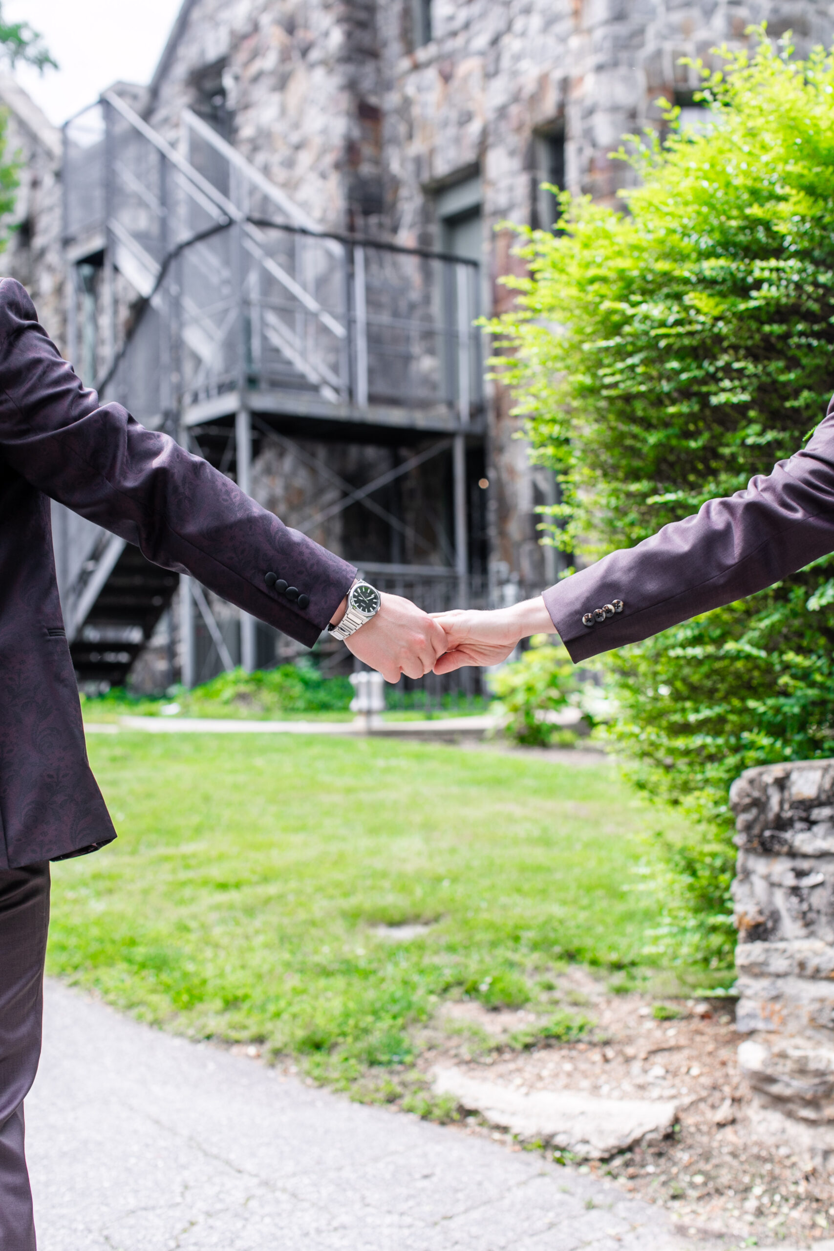 two men holding hands