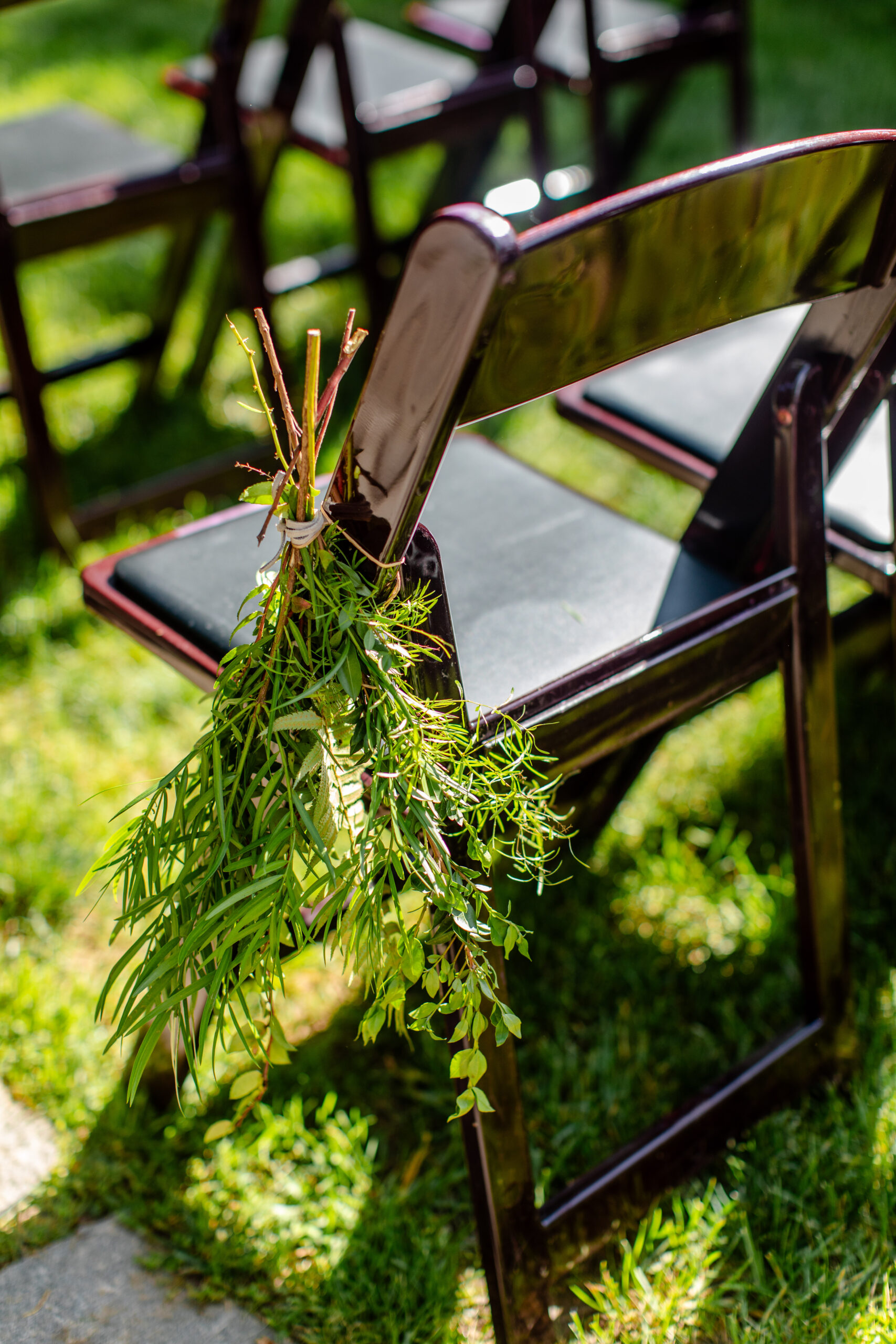 a chair with a plant tied to it  