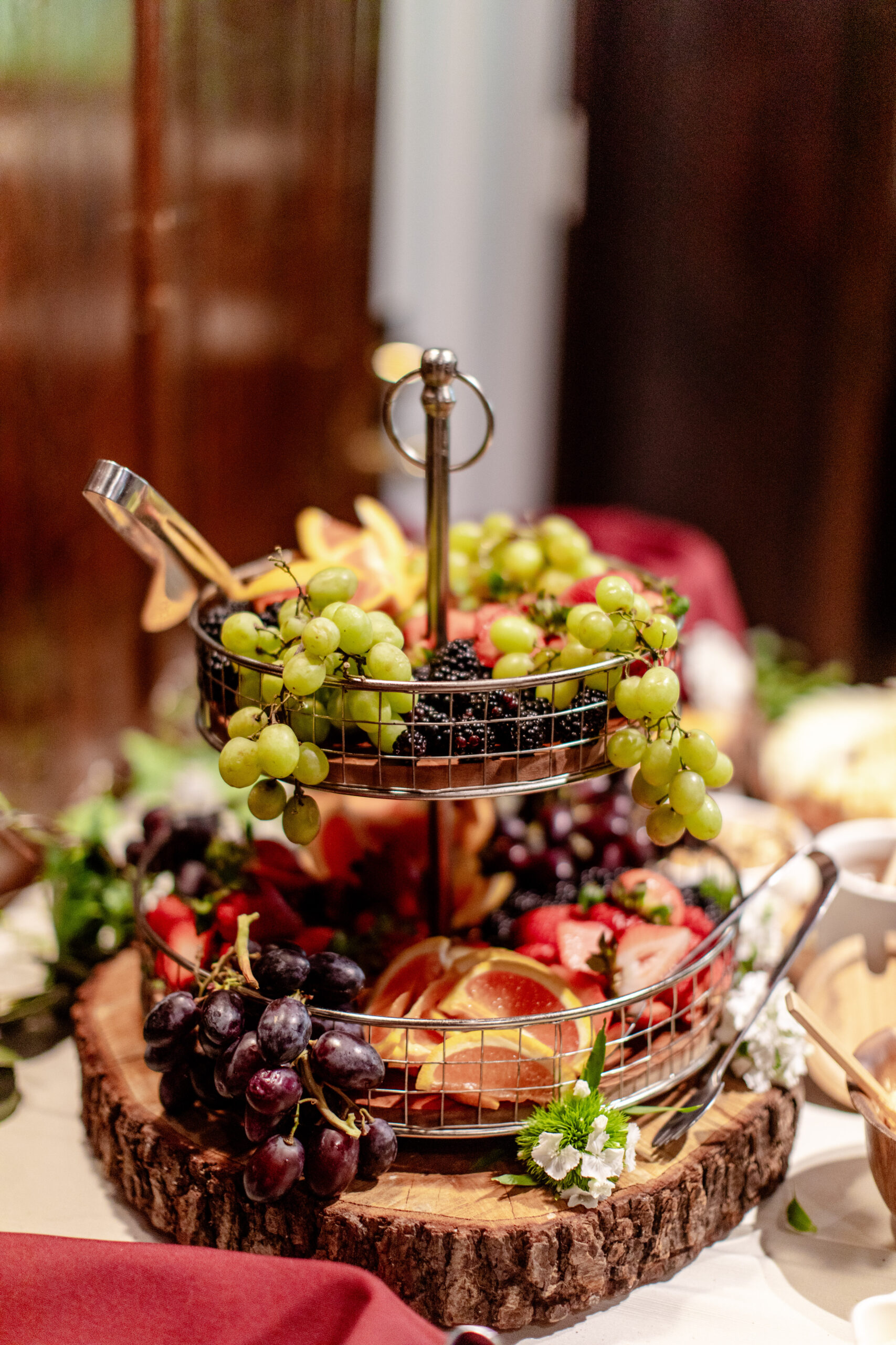 a basket of fruit with grapes, berries, and gits 