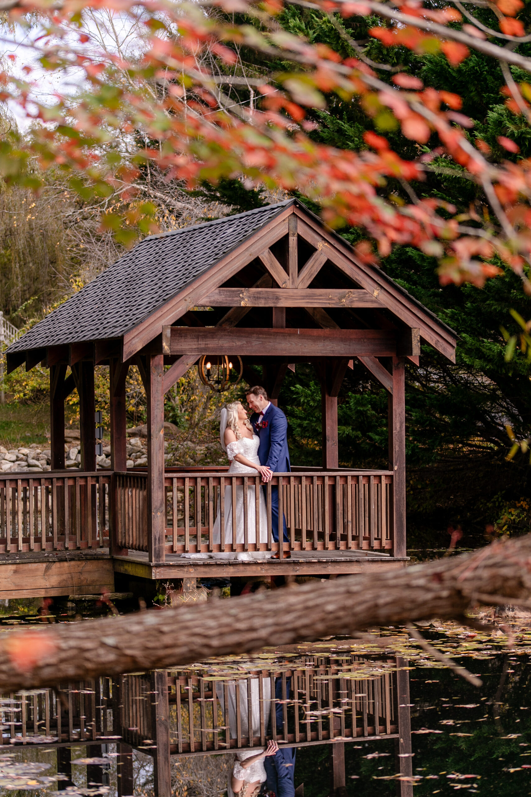 bride and groom in a gazebo by the water