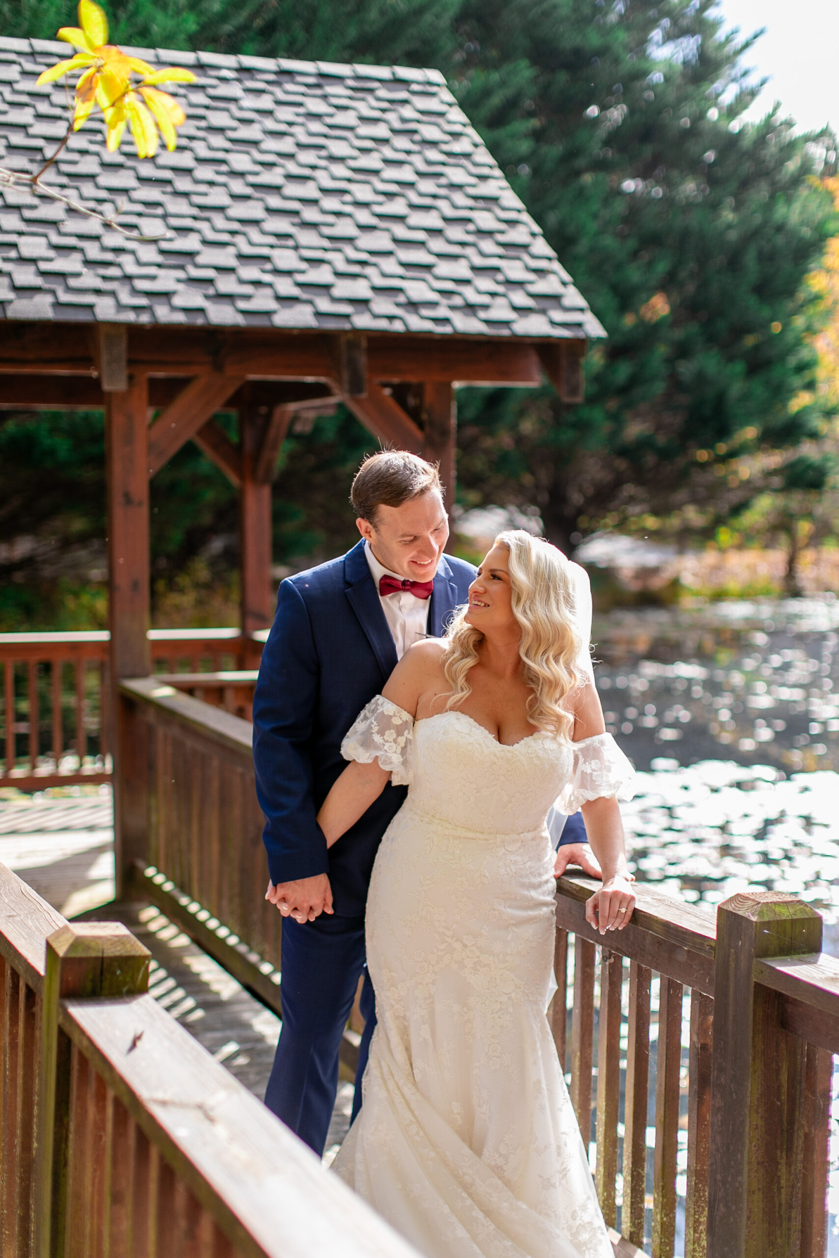 bridge and groom on a bridge looking at each other 