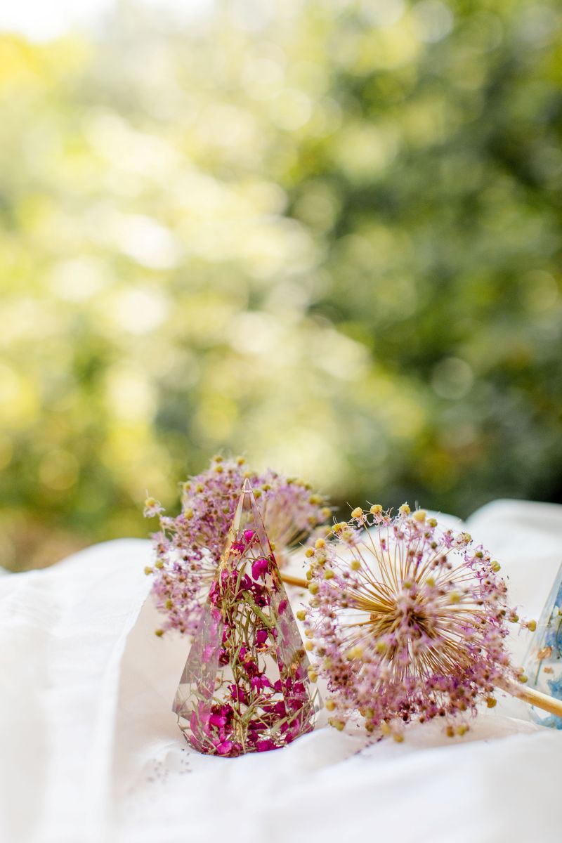 a ring holder that is a prism shape with flowers preserved inside 