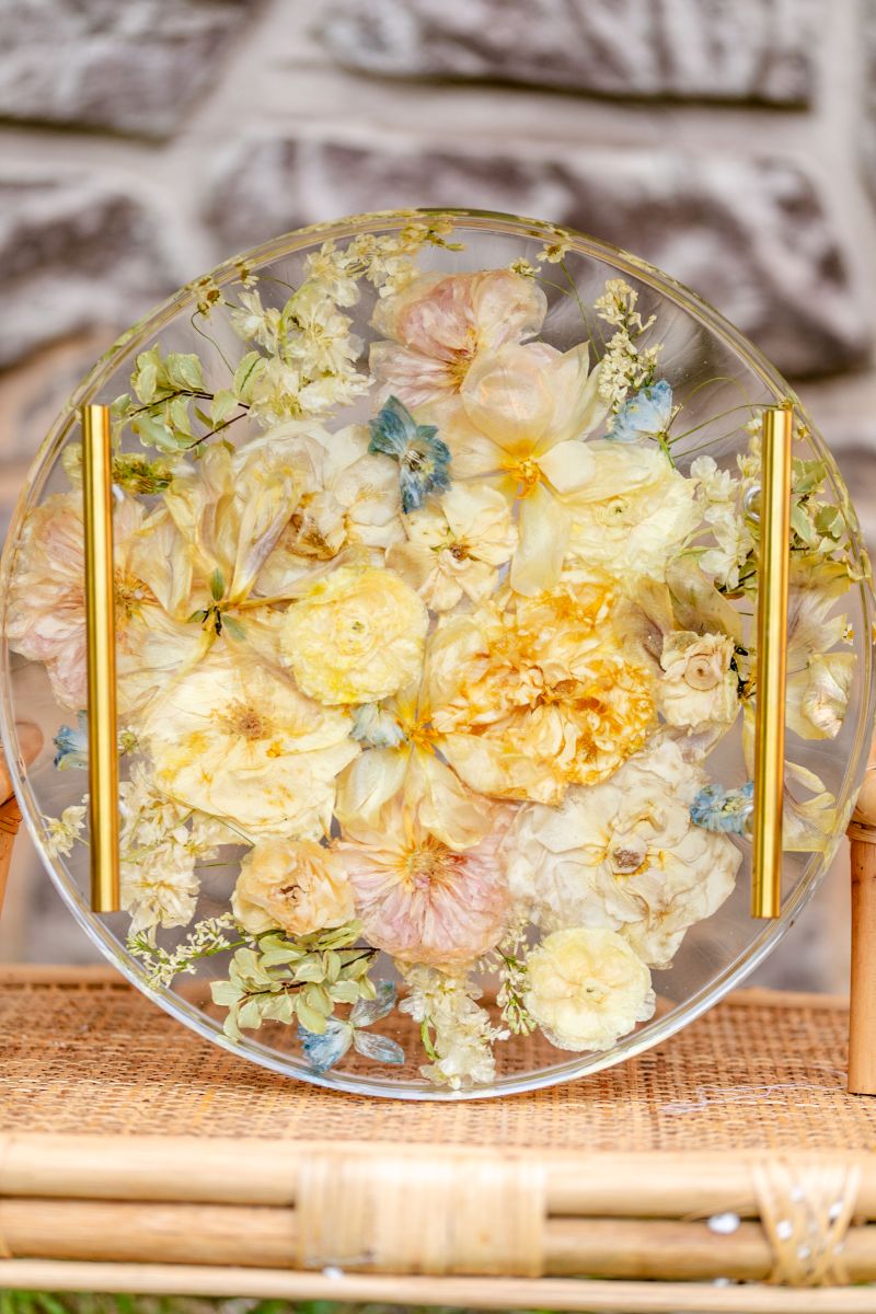 a circle block made of glass with flowers preserved inside 