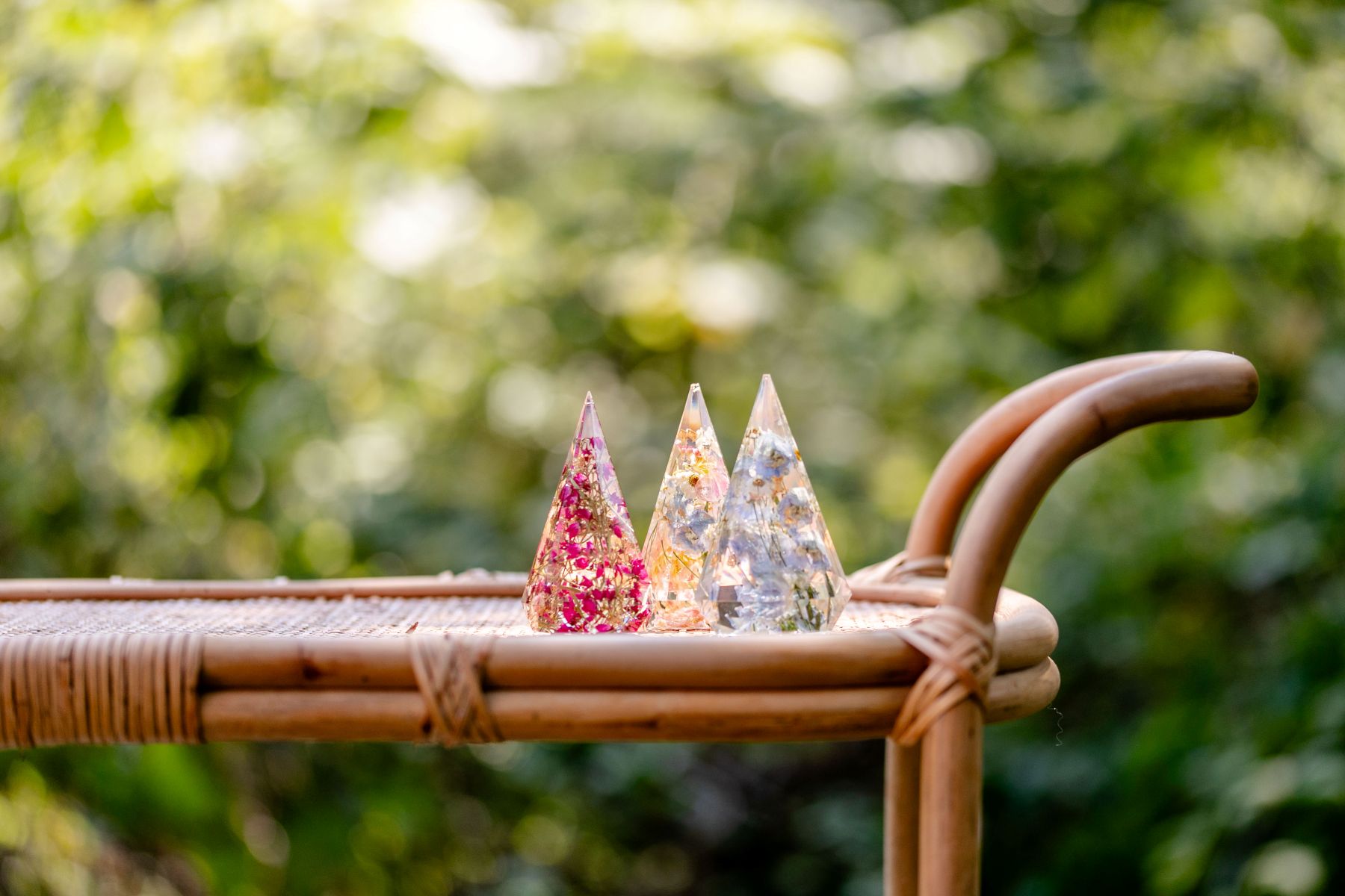 three prism shaped items with flowers inside on top of a wooden cart 