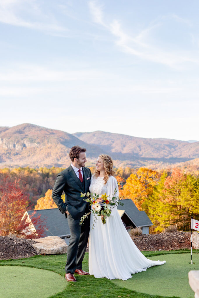 Asheville elopement couple standing together with fall mountain views in the Blue Ridge Mountains after their intimate ceremony