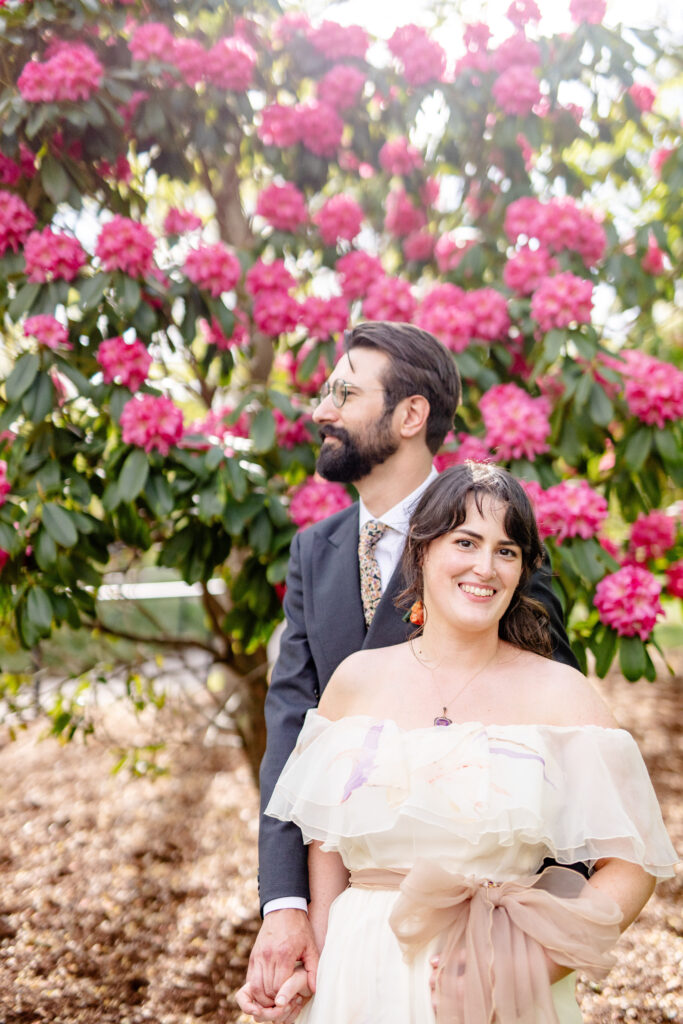 Couple during a Blue Ridge Mountains elopement standing beneath blooming rhododendrons in Asheville North Carolina