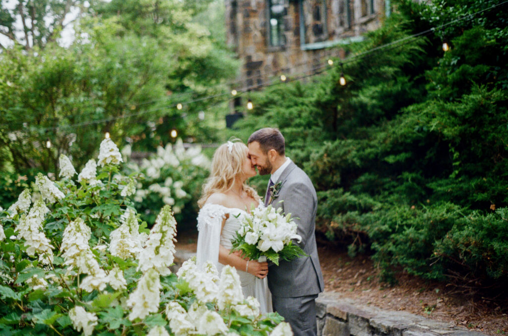 Bride and groom sharing a quiet moment among gardens at Homewood in Asheville