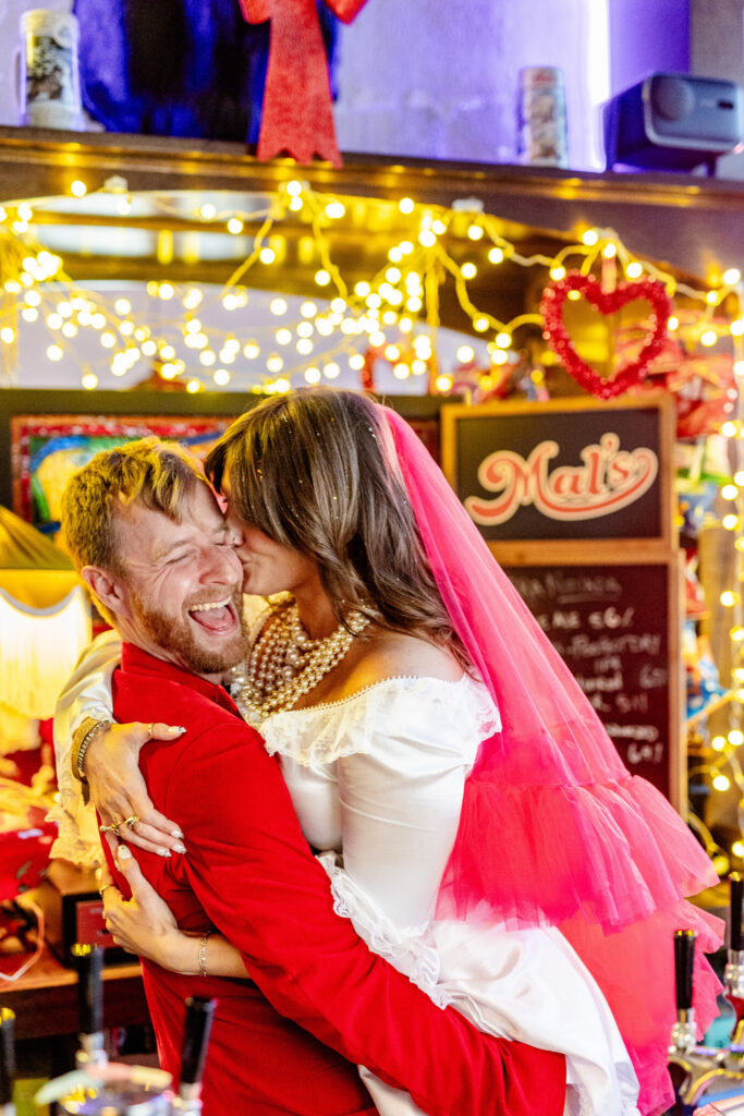 bride and groom embracing at a vibrant and eclectic downtown Asheville NC wedding
