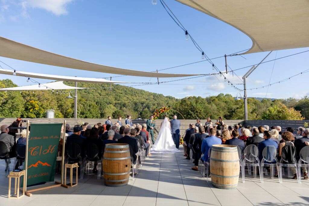 outdoor rooftop wedding ceremony at Highland Brewing Company in Asheville NC with mountain views and fall foliage