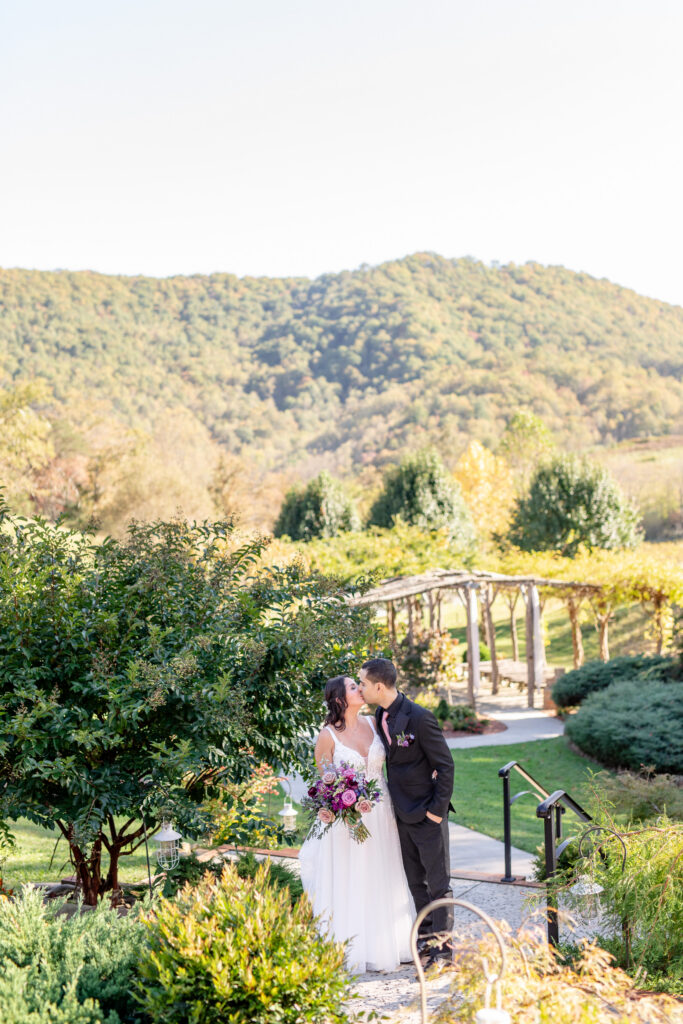 Wedding couple kissing in the mountains of Asheville, North Carolina beautiful fall mountain wedding 